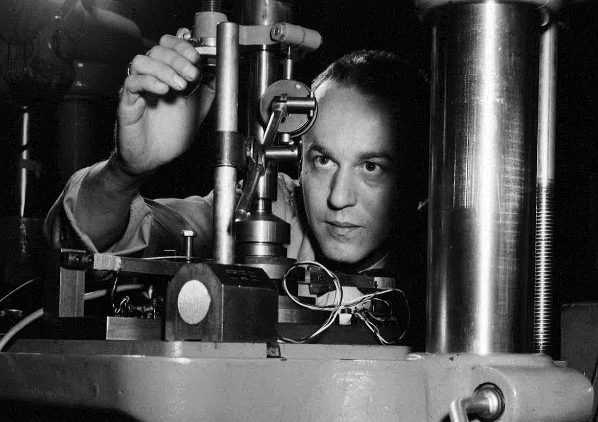 A close-up photo of a man working on a large machine